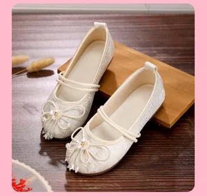 Detail view of white mesh Hanfu embroidered flat shoes with pearls and flower decor