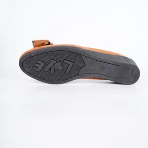 Detailed view of the anti-slip rubber sole on a brown wedge shoe featuring Love text