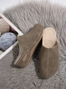 Cozy winter wedge mules featuring soft fleece lining and a durable thick sole on gray fur