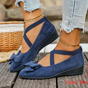 Close-up detail of navy blue wedge shoes featuring crossover straps and a 3.5cm heel height.