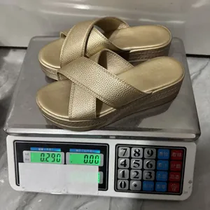 Stylish women's gold platform wedge sandals weighing 0.29 kg on a digital scale