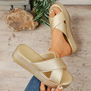 Detailed macro view showing the textured gold finish of stylish platform wedge sandals