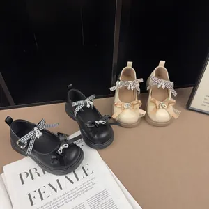 Detailed view of vintage girls' Mary Jane shoes featuring elegant bows and pearl accents.