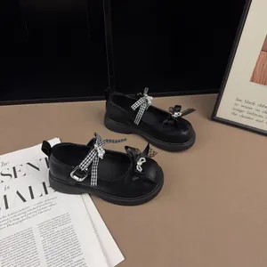 Elegant black children's Mary Jane shoes with plaid bow and pearl details