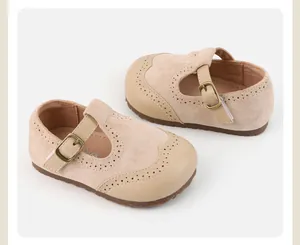 Close-up of beige baby Mary Jane shoes with soft anti-slip soles and decorative perforations.