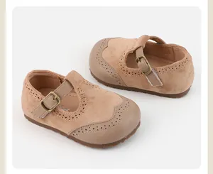 Classic tan suede baby Mary Jane shoes with delicate brogue detailing and soft sole.