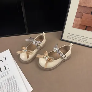 Close-up of vintage-style Mary Jane shoes featuring elegant bows and pearl accents
