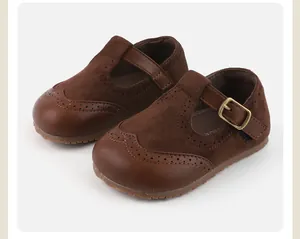 Detail of brown baby girl Mary Jane shoes with suede texture and buckle strap