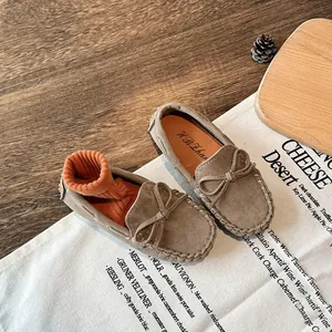 Classic children's suede loafers with bow detail and stylish white stitching