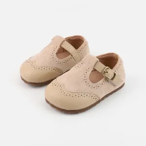 Beige suede baby Mary Jane shoes featuring brogue perforations and soft non-slip rubber soles