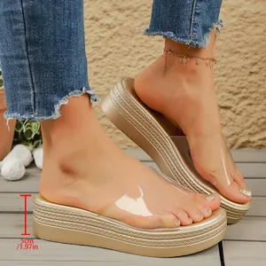Detail view of golden platform sandals with transparent strap and 5cm wedge