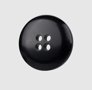 Close-up macro detail of a premium 4-hole black resin button for high-end clothing