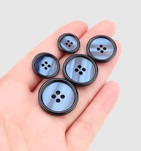 Close-up of high-end pearlescent resin buttons in various sizes for coat accessories.