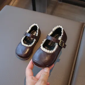 Vintage dark brown girls Mary Jane shoes with delicate white lace trim and soft sole