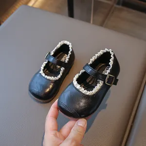 Elegant girls' black leather Mary Jane shoes with white ruffle trim and soft anti-slip soles.