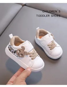 Detailed view of white children's toddler walking shoe with cute cartoon puppy design.