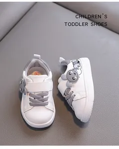 Detail view of white toddler walking shoes with cute cartoon caterpillar accents