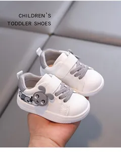 Detailed close-up view of white and gray soft-sole toddler shoes with cute cartoon mouse design