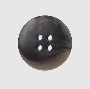 Detailed macro view of a dark marbled resin four-hole button used for high-end apparel