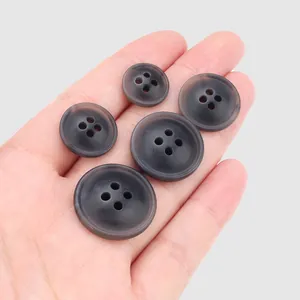 Assorted dark grey resin buttons in five sizes for high-end clothing accessories
