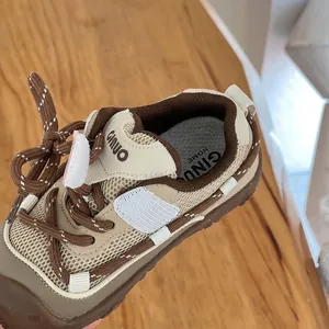 Detailed macro view showing breathable mesh upper and stitching on children shoe