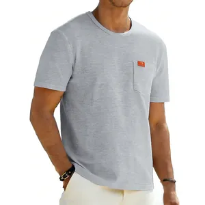 Detail view of a men's oversized grey t-shirt with a functional chest pocket