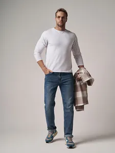 Professional full-length view of men's classic blue straight-leg denim jeans on a model