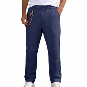 Close-up of men's navy blue loose linen trousers with an adjustable drawstring waist