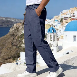Detail of men's loose navy blue linen trousers with elastic drawstring waist