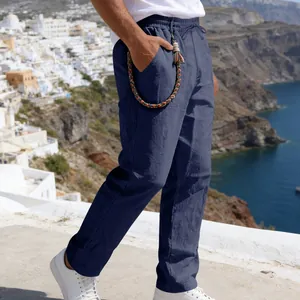 Detailed side view of men's loose blue linen casual pants with a drawstring waist