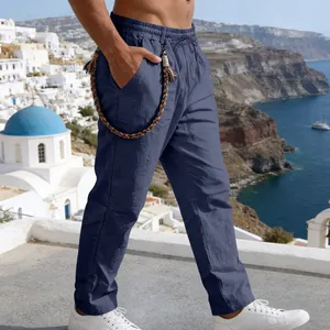 Side view of men's navy blue linen trousers with a colorful braided rope detail. Relaxed fit.