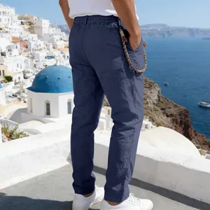 Detail of navy blue linen trousers for men featuring elastic waist and braided string