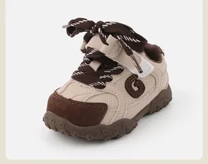 Side view of beige baby walking shoes with brown laces and soft anti-slip rubber sole