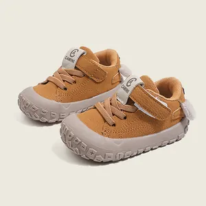 Comfortable brown baby walking shoes with soft soles and cute cartoon heel detail.