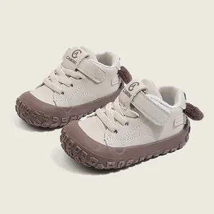 Soft sole baby toddler walking shoes with velcro strap and cute cartoon heel detail in beige