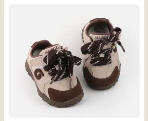 Detailed view of beige and brown colorblock baby toddler sneakers with patterned laces