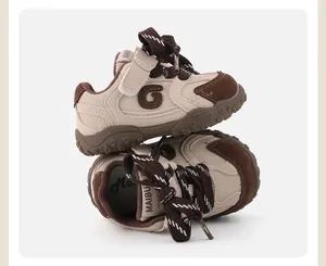 Detail view of brown and beige patchwork baby sneakers with soft soles and velcro.