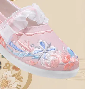 Close-up of pink girls' Hanfu shoe featuring intricate floral embroidery and ruffles