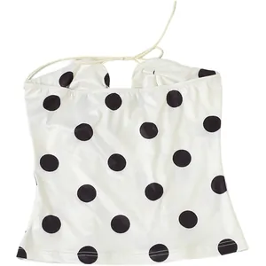 Detailed view of a white polka dot tube top with elegant tie-up strings