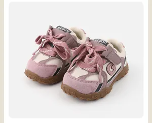 Detailed view of pink and cream baby walking shoes with soft anti-slip rubber soles