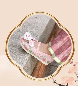 Detail view of pink Hanfu embroidered girl shoes with cute rabbit and strawberry patterns