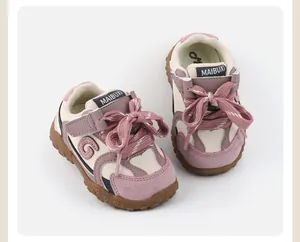 Detailed macro view of pink and beige toddler walking shoes with soft rubber soles