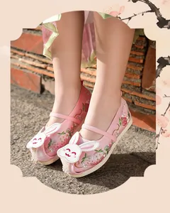 Close-up of pink Hanfu embroidered shoes for girls featuring a cute rabbit and floral motifs