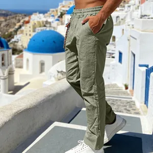 Model wearing casual green linen-look straight-leg pants in a scenic outdoor setting