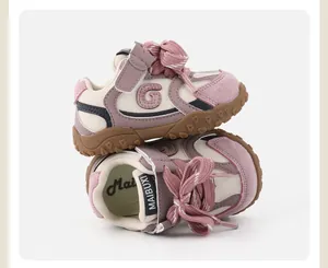 Close-up detail of pink color-block toddler sneakers with soft soles and velcro strap