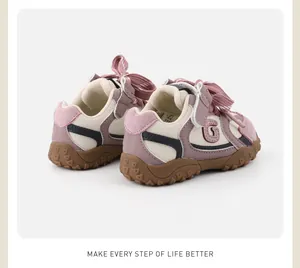 Detailed view of pink and cream toddler walking shoes with soft soles and ribbon laces