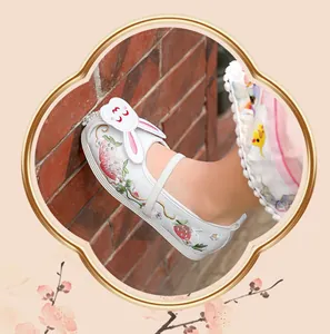 Close-up of children's Hanfu embroidered shoes with cute 3D rabbit and strawberry pattern
