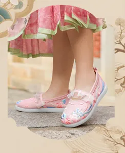 Detail of pink embroidered Hanfu shoes for girls with lace and floral patterns