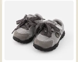 Close-up of grey toddler sneakers with soft soles and thick charcoal rope laces
