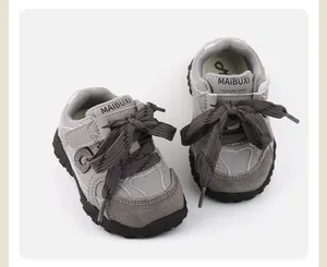 Grey baby soft sole walking sneakers with contrast stitching and dark grey laces